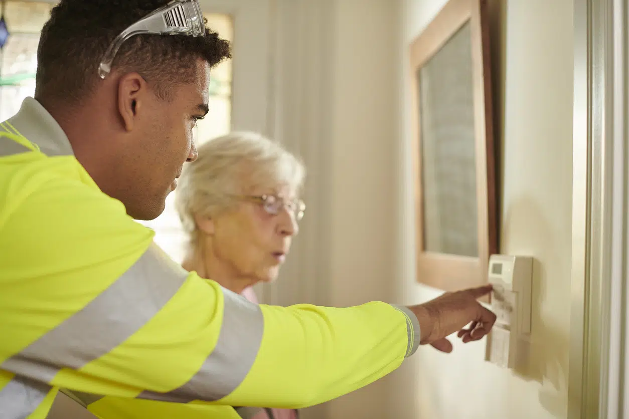 senior woman getting tuition on using burglar alarm image