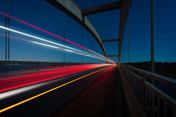 lights from vehicle on road creating lines in night sky image